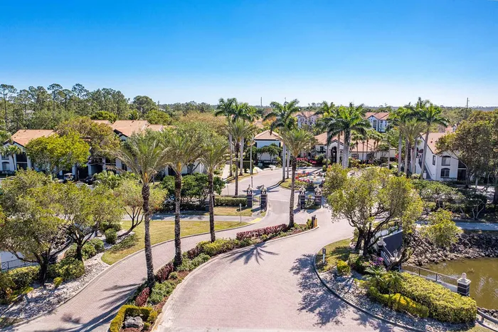 Luxurious apartment community with lush landscaping, palm trees, and elegant architecture, offering a serene and upscale living experience.