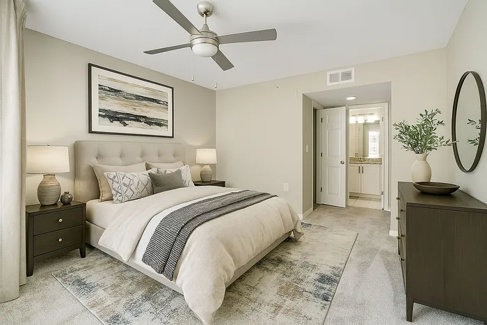 Elegant bedroom with plush bedding, stylish decor, and an en-suite bathroom, creating a serene and inviting atmosphere.