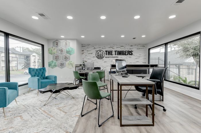 Tables and seating in the clubhouse at  at The Timbers apartments