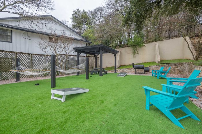 Lawn area with games, loungers, grills and hammocks  at The Timbers apartments