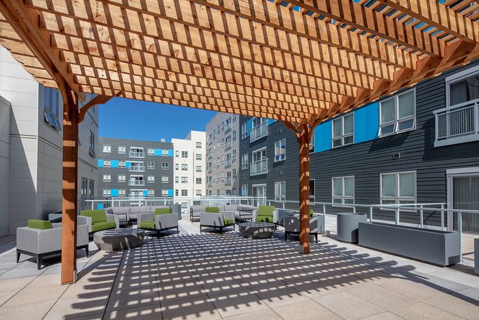 Shaded courtyard with comfortable seating at Theory Syracuse | Off--Campus Apartments.