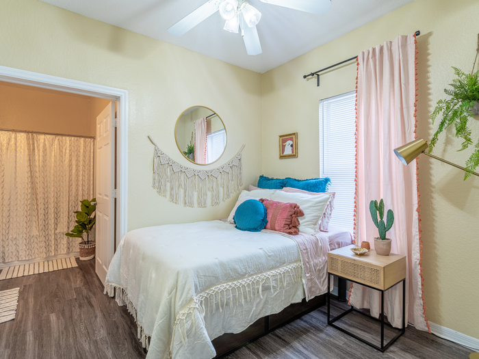 Charming bedroom view | Sizable bed | Draping curtains |  Ceiling fan | Hawks Landing | Apartments in Tampa, FL