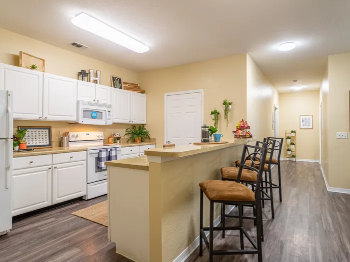 Well light kitchen complete with island and serving bar | refrigerator, oven, and microwave are included | Ample cabinet and counter top space | Hawks Landing