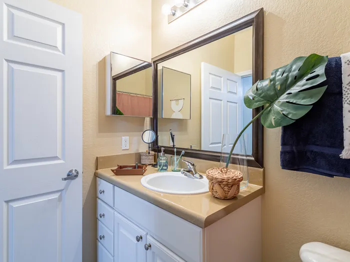 Bathroom with vanity mirror and cabinetry | Shower and tub visible | Hawks Landing | Apartments in Tampa, FL