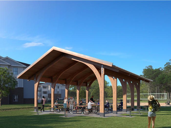 Residents enjoying outdoor pavilion with grills at 698 Prospect | Apartments in Pembroke