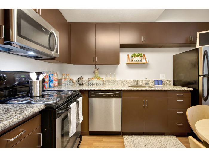 Kitchen with dark cabinetry | University Gateway Apartments in Los Angeles, CA.