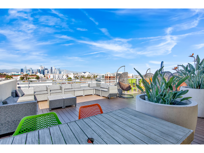 Close-up of table and seating on outdoor patios | University Gateway Apartments in Los Angeles, CA.