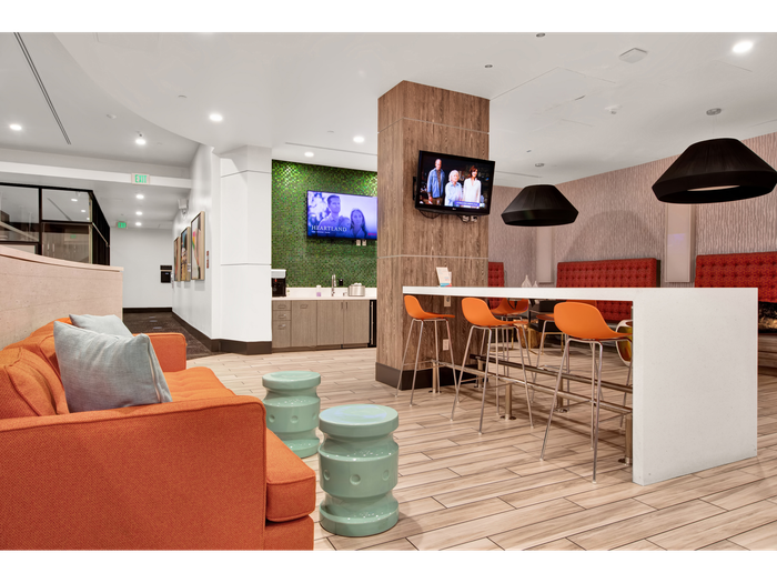 Flat screen TVs and seating in common area | University Gateway Apartments in Los Angeles, CA.