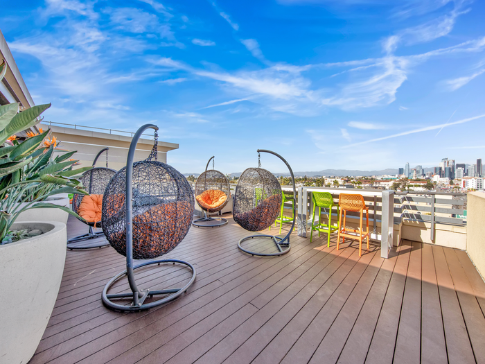 Hanging seats on outdoor deck | University Gateway Apartments in Los Angeles, CA.
