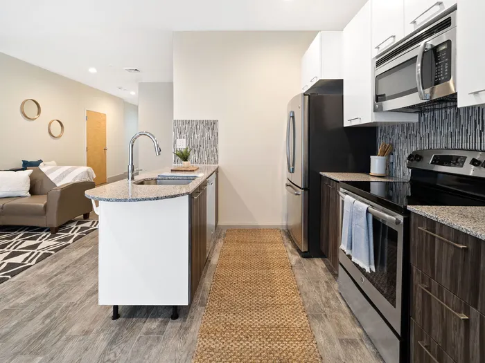 Kitchen-living area in an apartment at The Printing House | Binghamton Apartments