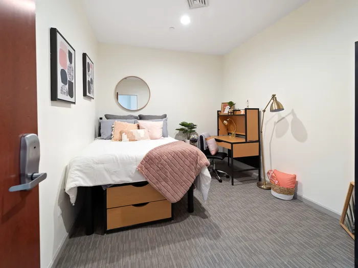 Bedroom with carpet and desk at The Printing House | Binghamton Apartments