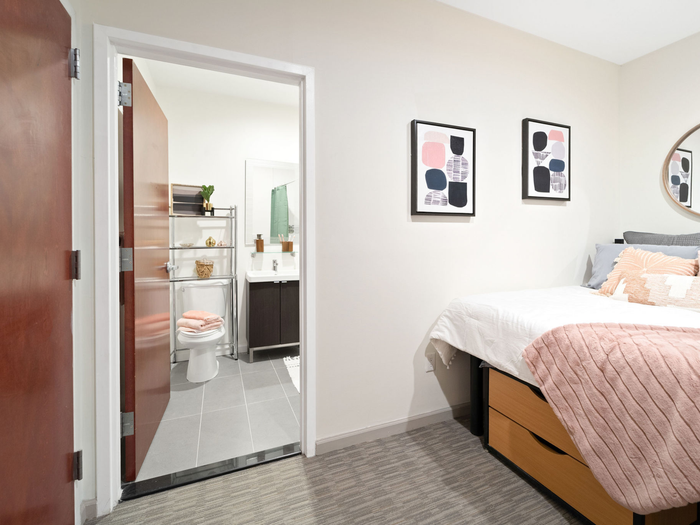 Bedroom opening into bathroom at The Printing House | Binghamton Apartments