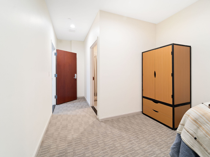 Detail of bedroom highlighting storage at The Printing House | Binghamton Apartments