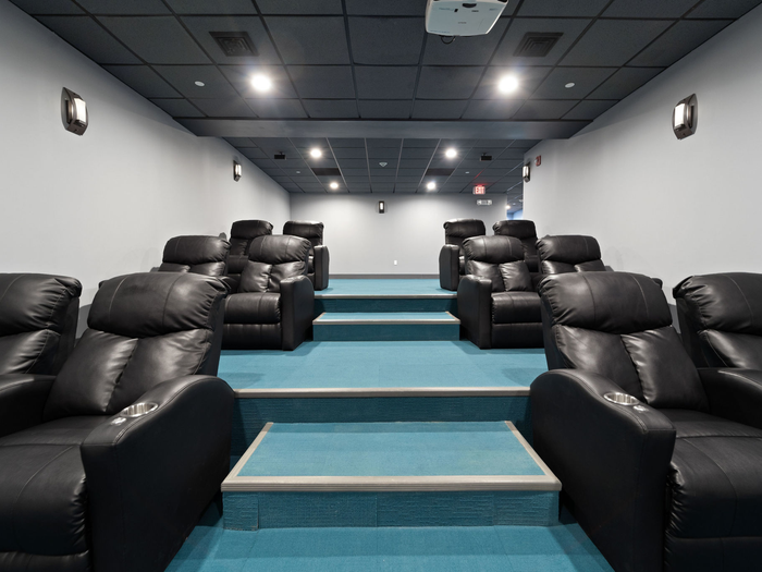 Theatre room with reclinersat The Printing House | Binghamton Apartments