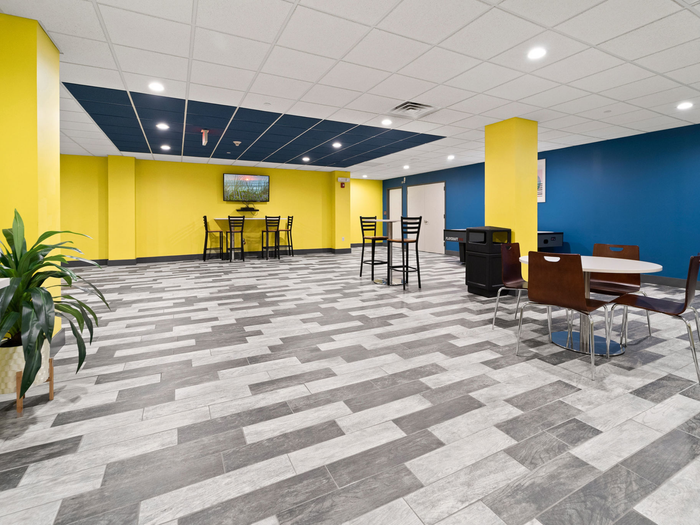 Open area with seating on the side at The Printing House | Binghamton Apartments