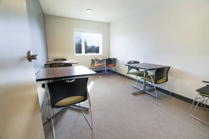 Tables for two in common area at Tech Village | Student Apartments Appleton