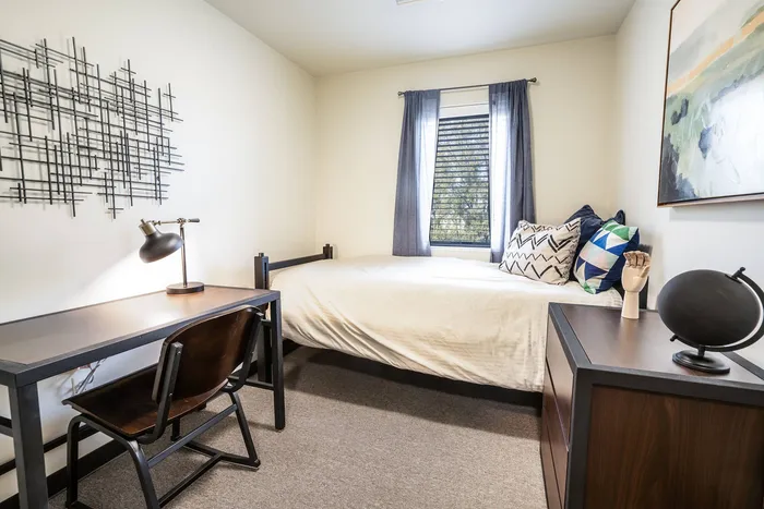 Furnished bedroom in student apartments at Tech Village.