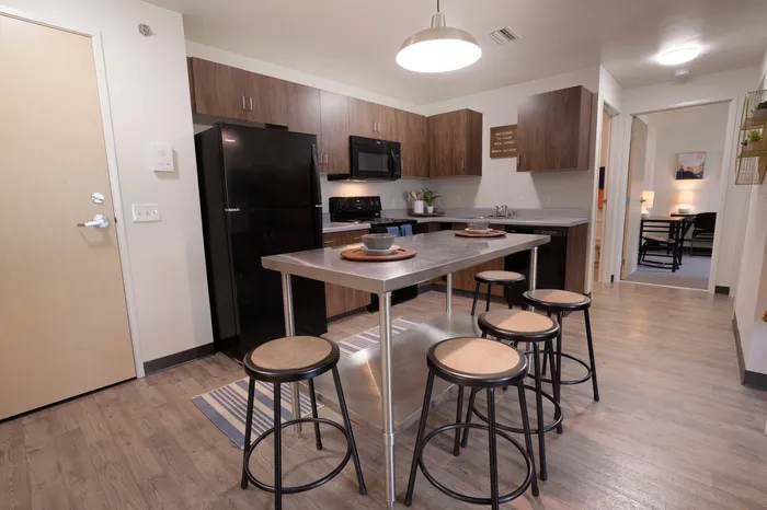 Kitchen with dining area in student apartments at Tech Village.