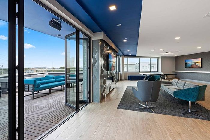 Thoughtfully designed Resident Club House with Comfortable Seating  Opening onto Outdoor Deck | Bixby Kennesaw | Apartments Near Kennesaw State University