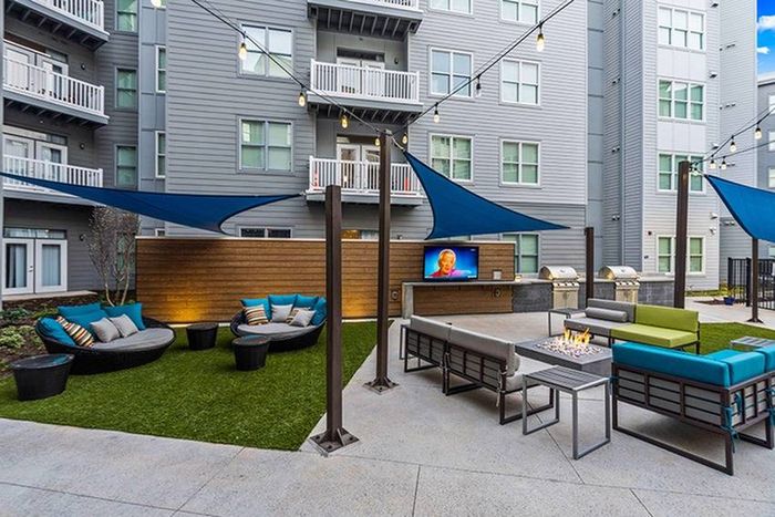 Outdoor Courtyard with Big-Screen TV, Seating, Grills, and Fire Pit | Bixby Kennesaw | Kennesaw, GA Apartments