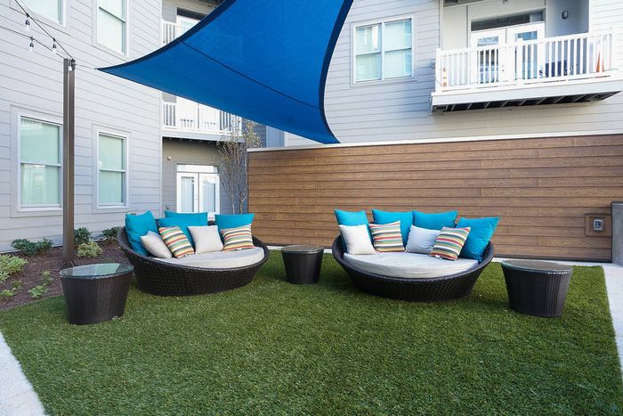 Seating in Outdoor Grassy Area with Shade at Bixby Kennesaw | Apartments Near Kennesaw State University