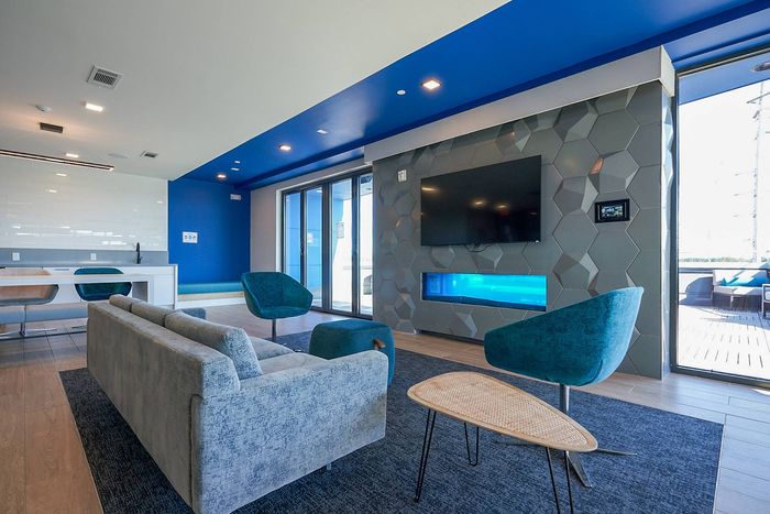 Flat-Screen TV, Couches & Chairs in Spacious Resident Club House | Bixby Kennesaw | Kennesaw Apartments Near KSU