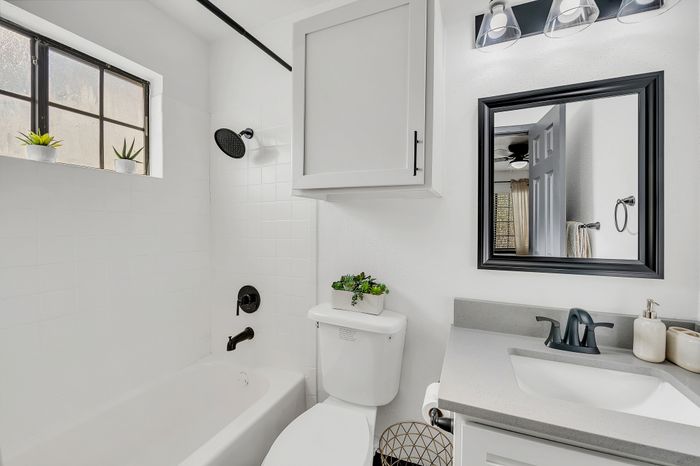 Bright and modern bathroom with sleek fixtures and crisp white tiles.