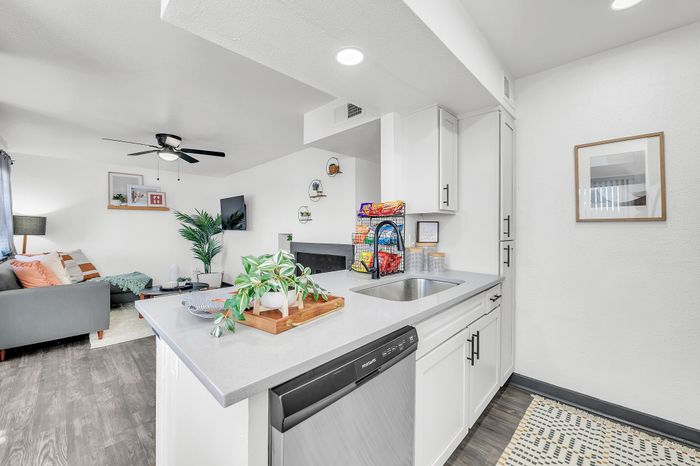 Modern open-concept kitchen and living area with sleek design and stylish furnishings.