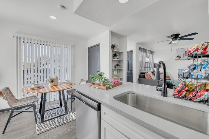 Bright and airy interior showcasing a stylish kitchen area, cozy living room, and a charming dining nook with natural light.