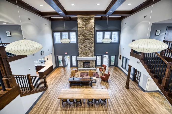View from top of stairs of clubhouse area including fireplace | 48 West | Allendale, Michigan