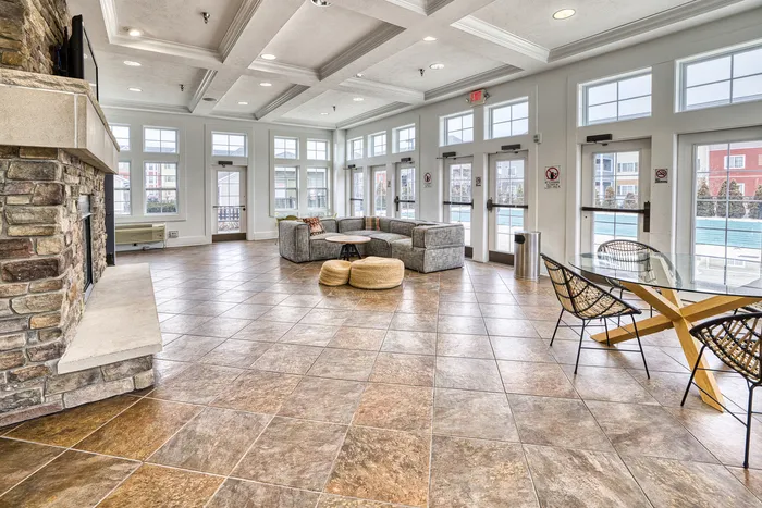 Fireplace, seating, and tables in common area at 48 West apartments in Allendale, Michigan