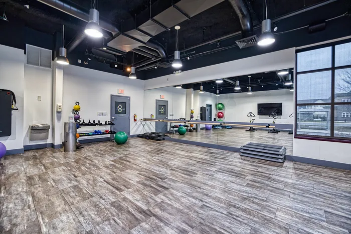 Woman Doing Yoga in Fitness Studio | 48 West | GVSU Off-Campus Housing in Allendale, MI