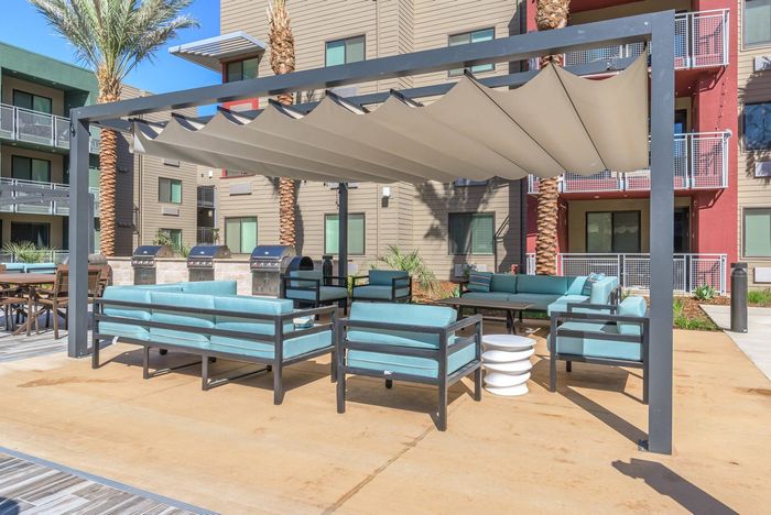 BBQ grills & covered patio area with seating  at Merced Station apartments