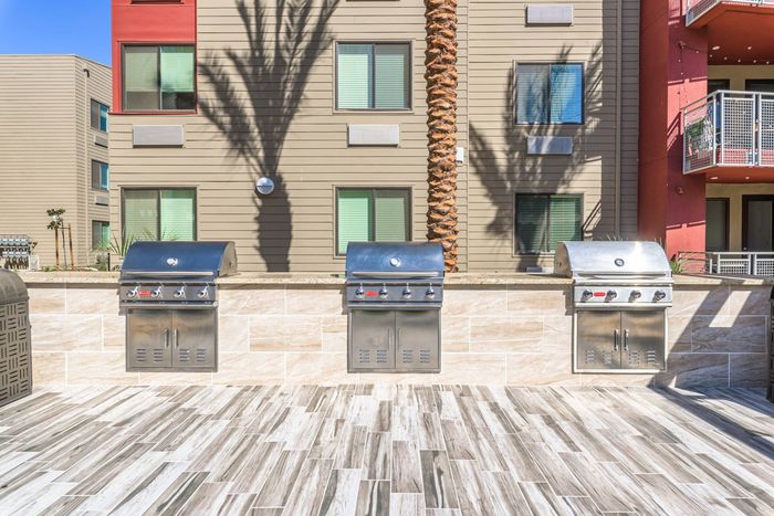 Multiple grills in outdoor communal area  at Merced Station apartments.