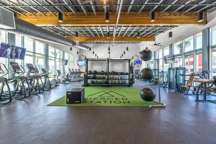 Fitness center with exercise equipment  at Merced Station apartments.