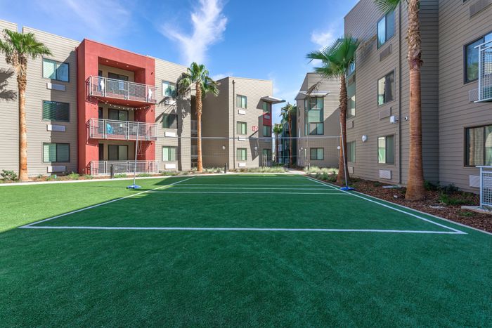 Outdoor volleyball court  at Merced Station apartments.
