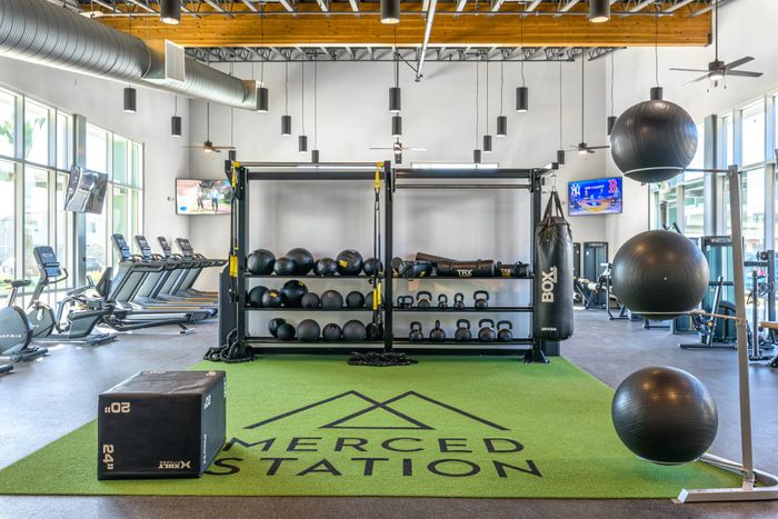 Fully equipped fitness center at Merced Station apartments.