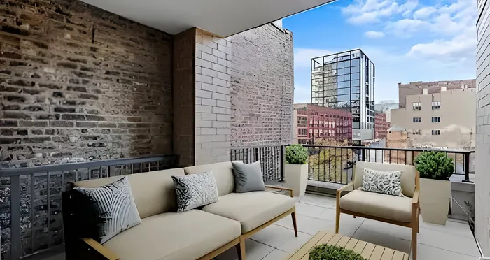 Chic urban balcony with modern seating, lush planters, and a captivating cityscape view.