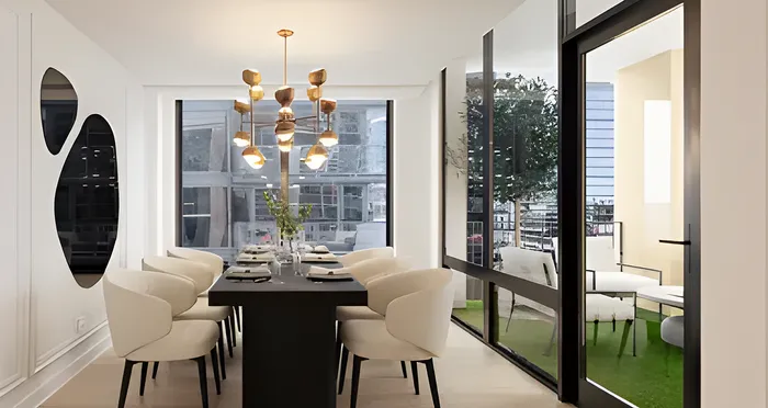 Elegant dining room featuring a modern chandelier, plush white chairs, and a large table set for a stylish gathering, with floor-to-ceiling windows offering a stunning view.