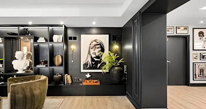 Modern living space with elegant black shelving, artful decor, and stylish framed artwork, offering a sophisticated ambiance.