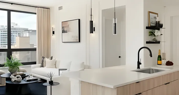Modern apartment interior with bright living room and stylish kitchen, featuring large windows, sleek countertops, and elegant decor.