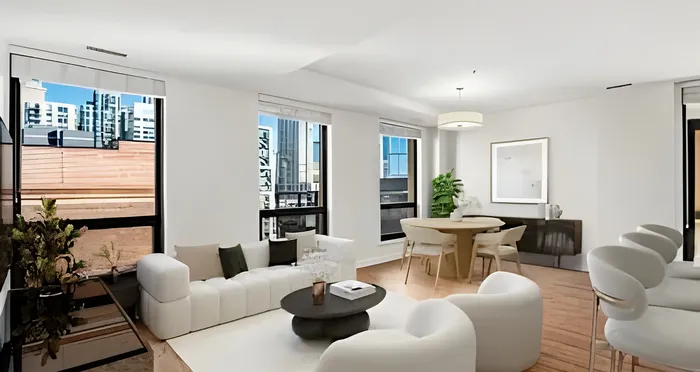 Bright modern living area featuring sleek white furniture, large windows with city views, and a stylish dining space.