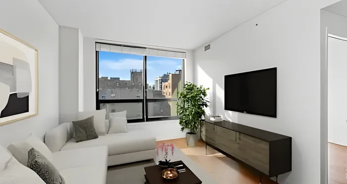 Bright and modern living room featuring a sleek sofa, wall-mounted TV, and a large window with a stunning city view.