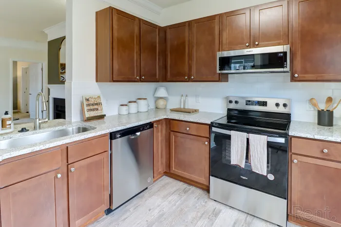 Modern kitchen with granite countertops, stainless steel appliances and subway tile backsplash