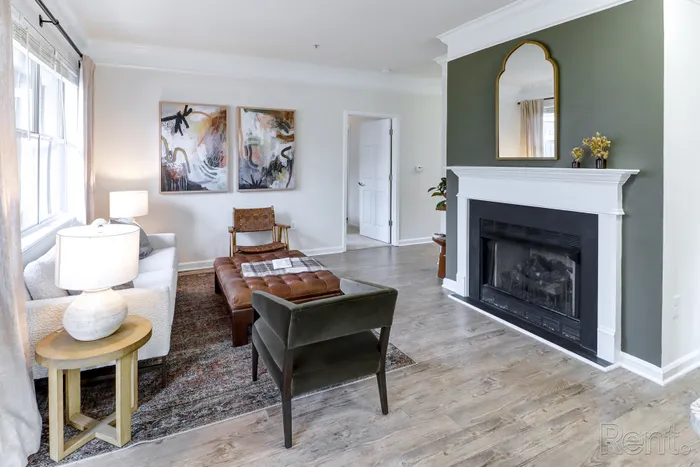 Elegant living room with stylish decor, featuring a cozy fireplace and modern furnishings.