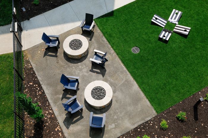 Cozy firepit and yard games area in the courtyard of Wheatfield Village Apartments, Topeka, KS.