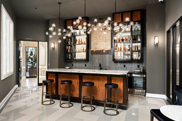 Resident Lounge with Elevated Bar and Modern Lighting - A stylish lounge area featuring an elevated bar and contemporary lighting, offering a sophisticated space for socializing.
