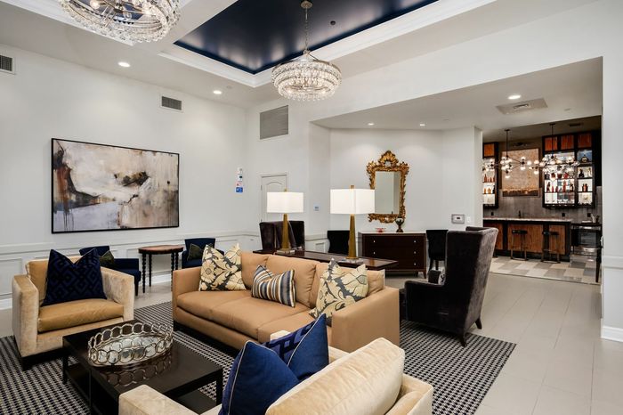 Resident Media Room and Lounge with Comfortable Seating and Television - A cozy media room with comfortable seating and a large television, providing residents a relaxing entertainment space.