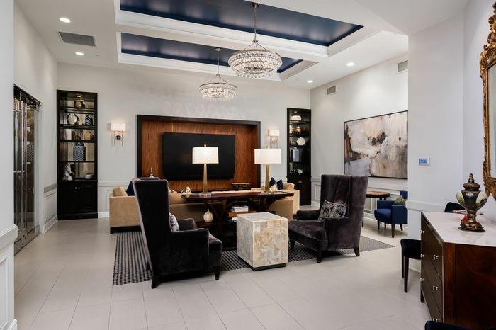 Resident Media Room and Lounge with Comfortable Seating and Television - A cozy media room with comfortable seating and a large television, providing residents a relaxing entertainment space.