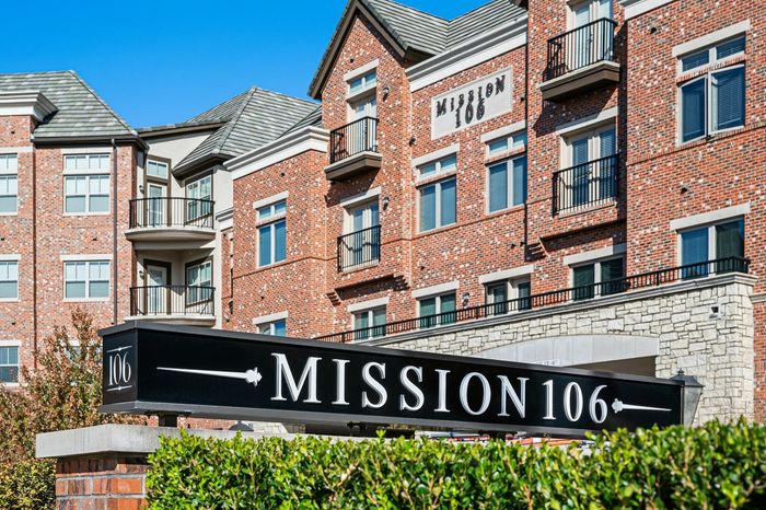 Exterior Shot of Community Showcasing Facade and Monument Mission 106 Sign - An exterior view capturing the community's facade and the monument sign of Mission 106.